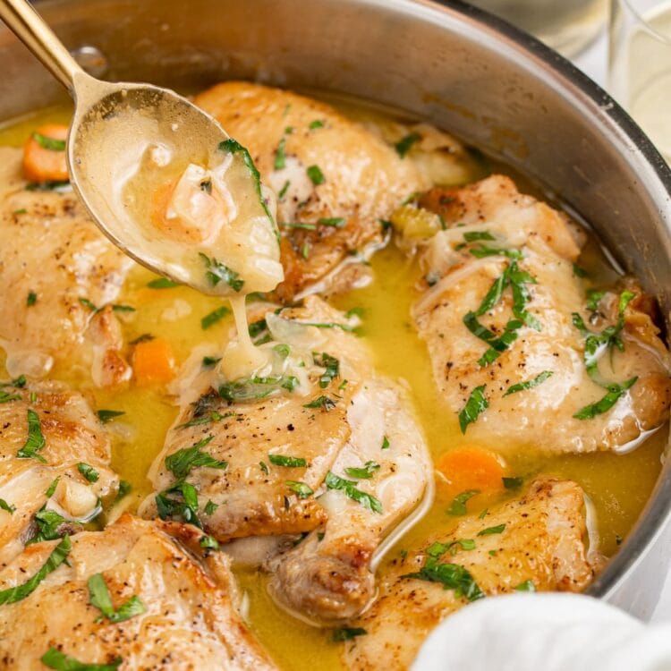 chicken fricassee in a skillet with a spoon