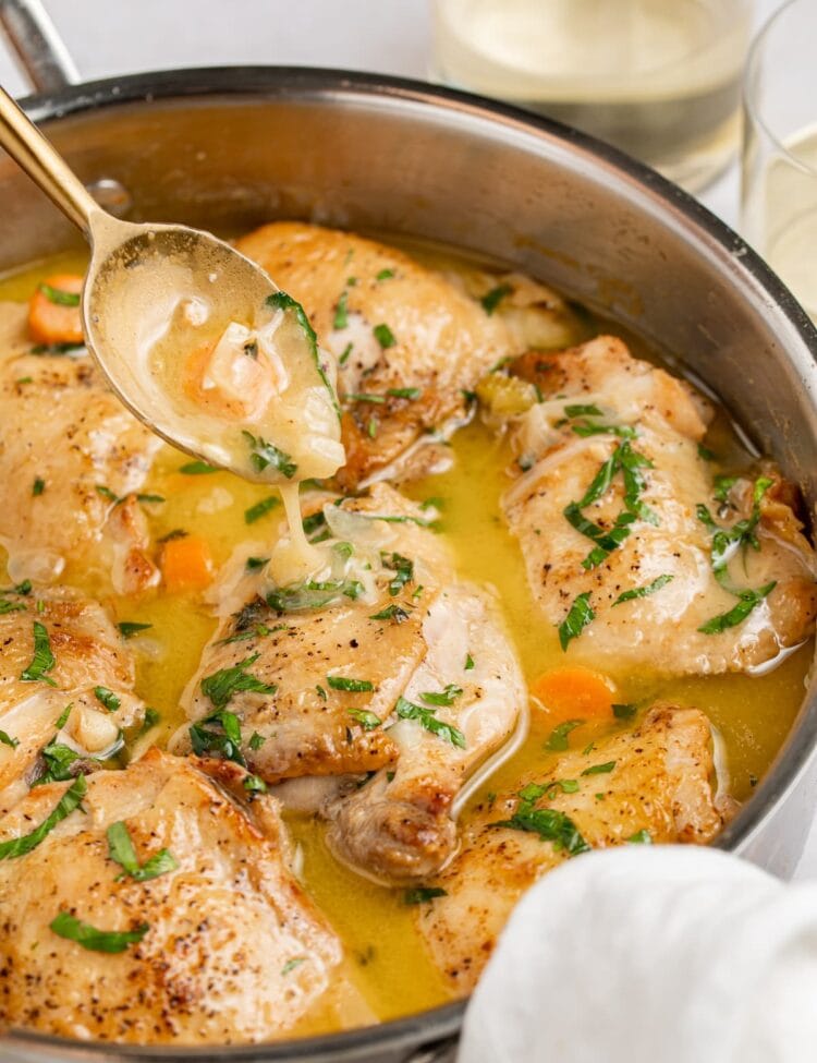chicken fricassee in a skillet with a spoon