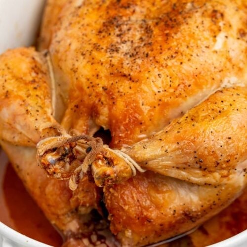 showing how to truss a chicken with a roasted chicken in a baking dish