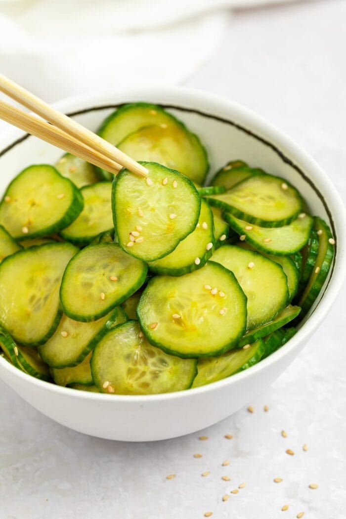 japanese cucumber salad in a bowl with chopsticks