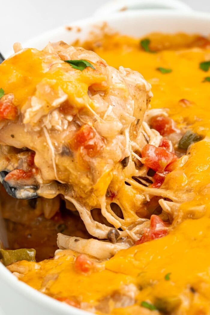 close up image of king ranch casserole being lifted out of the baking dish