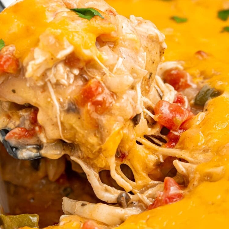 close up image of king ranch casserole being lifted out of the baking dish