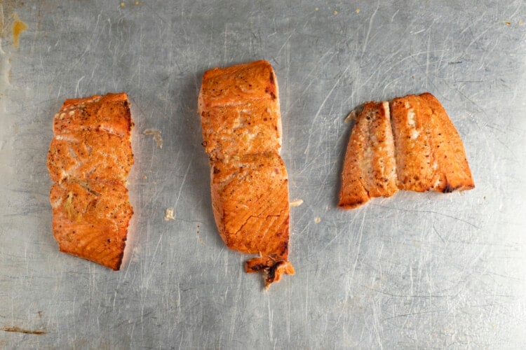 Broiled salmon fillets on baking sheet