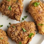 Gluten free fried chicken thighs and legs on a white plate