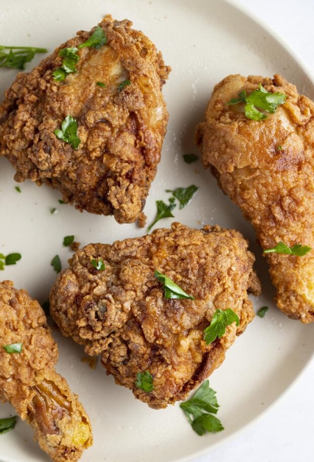 Gluten free fried chicken thighs and legs on a white plate