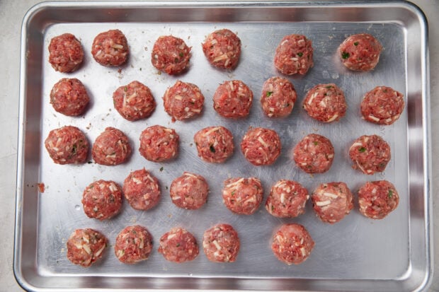 Rolled, uncooked keto meatballs on baking sheet