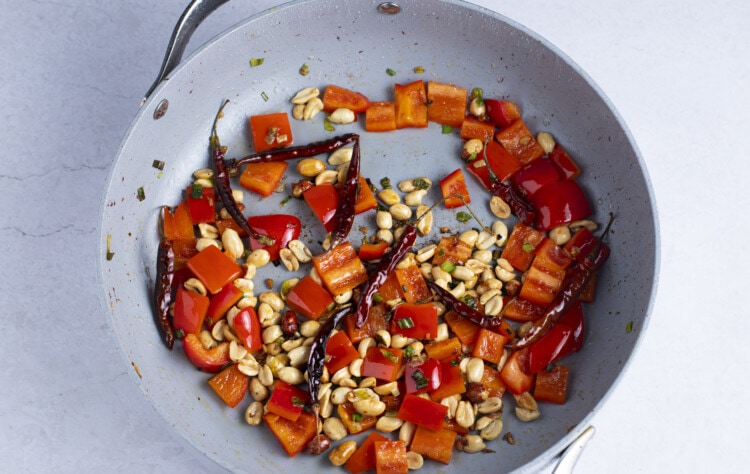 Bell pepper and peanuts in large skillet
