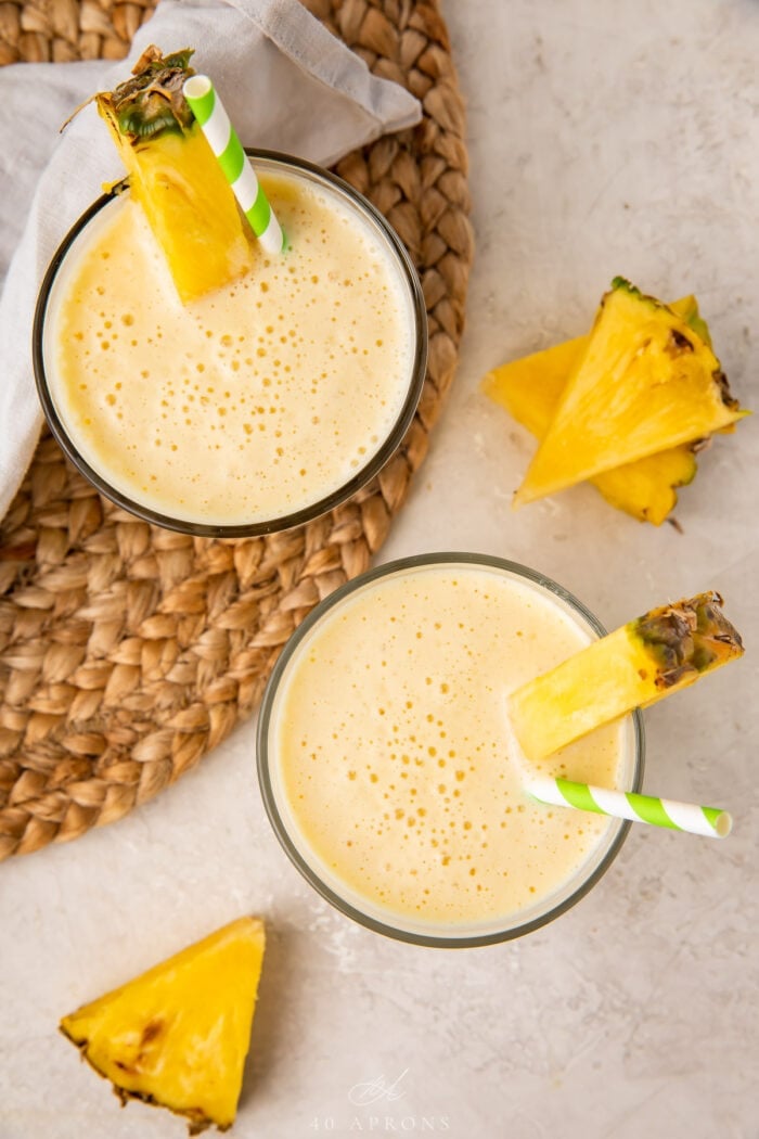 Overhead angle of 2 glasses of pineapple smoothie
