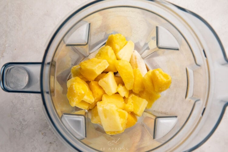 Ingredients for a pineapple smoothie in a blender