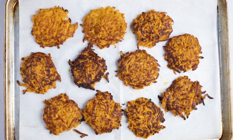 Sweet potato hash browns on baking sheet lined with parchment paper