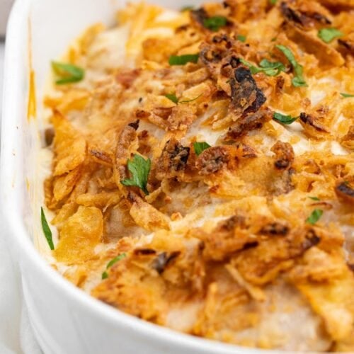 pork chop casserole in baking dish with fresh parsley on top