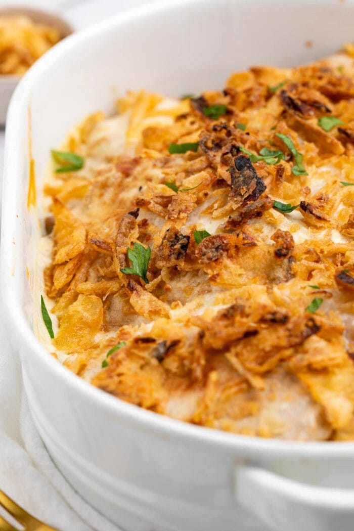 pork chop casserole in baking dish with fresh parsley on top