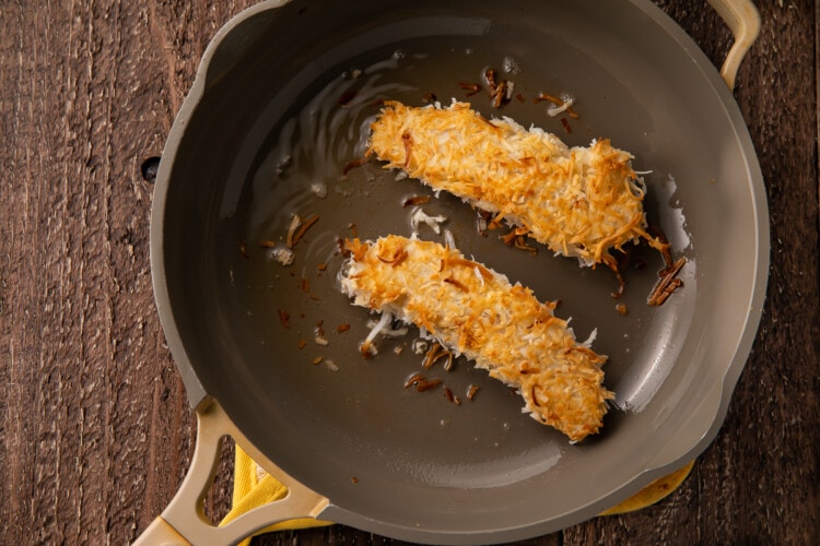 Fried chicken strips in large skillet