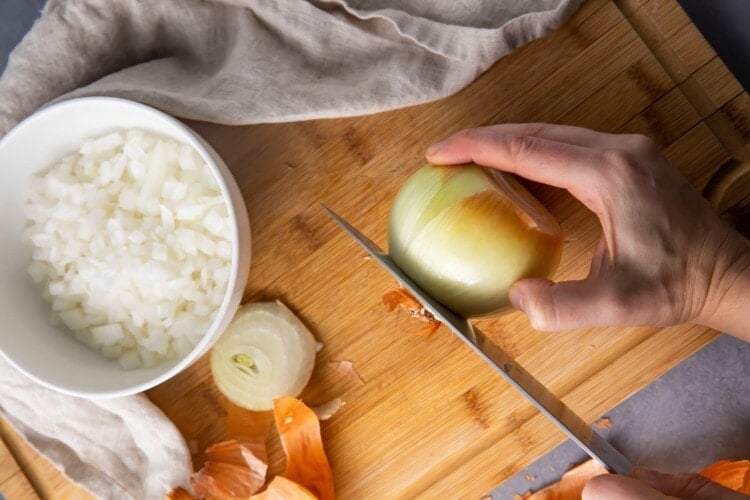Slice the ends off the onion with a sharp knife