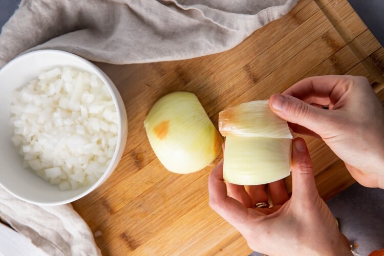 Peel away the outer layer of the onion halves