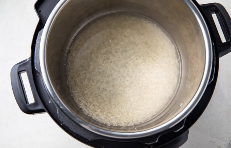 Uncooked jasmine rice and water in Instant Pot