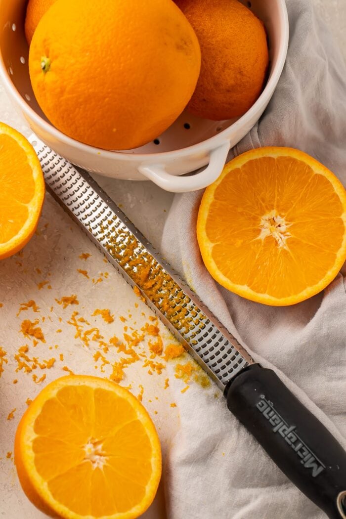 Oranges with orange zest and peeler