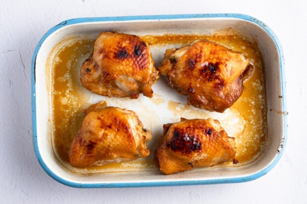 Cooked chicken thighs in baking dish
