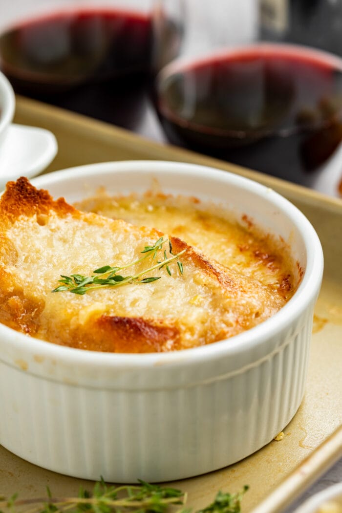 close-up image of instant pot french onion soup with red wine on the side