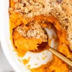 close up overhead image of sweet potato souffle with a spoon in it