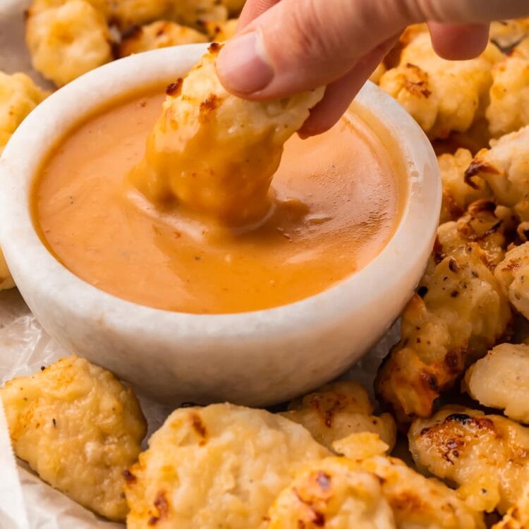 An air fryer chicken nugget dipped into copycat Chick-fil-a sauce