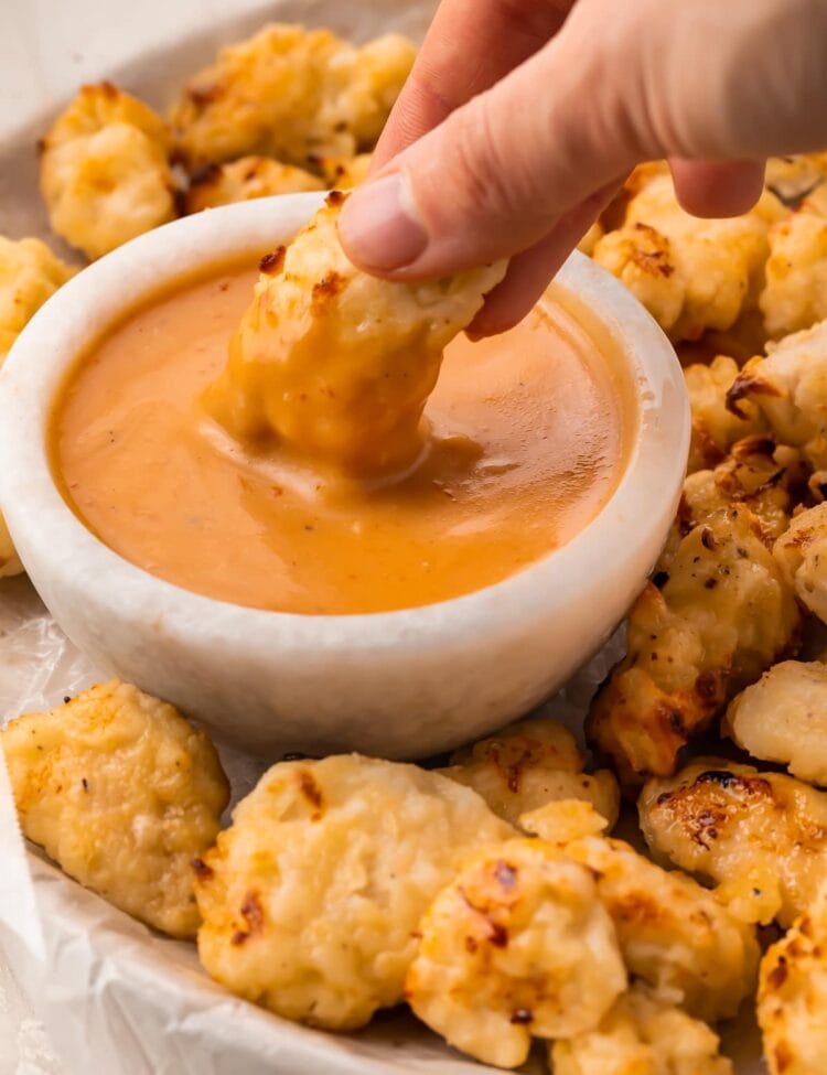 An air fryer chicken nugget dipped into copycat Chick-fil-a sauce