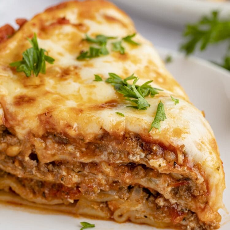 Close up view of a slice of Instant Pot lasagna on a white plate