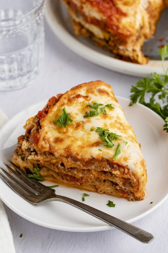 A wedge slice of Instant Pot lasagna on a white plate