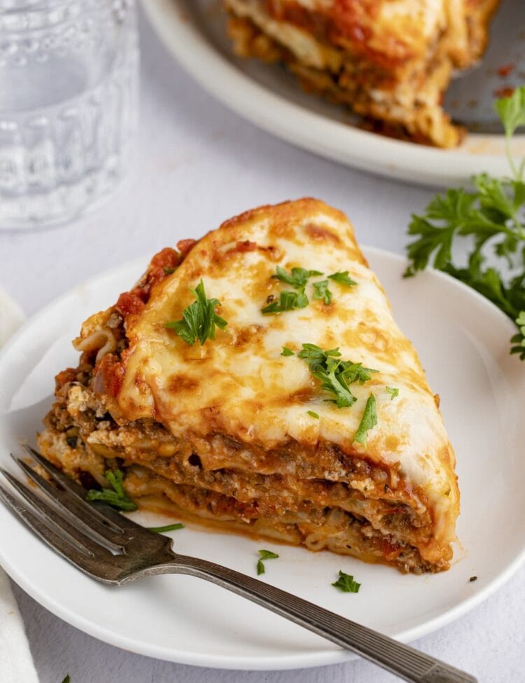 A wedge slice of Instant Pot lasagna on a white plate