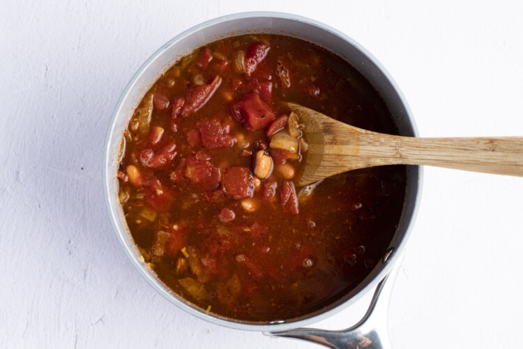 Vegetable stock, pinto beans, and fire-roasted tomatoes in large saucepan