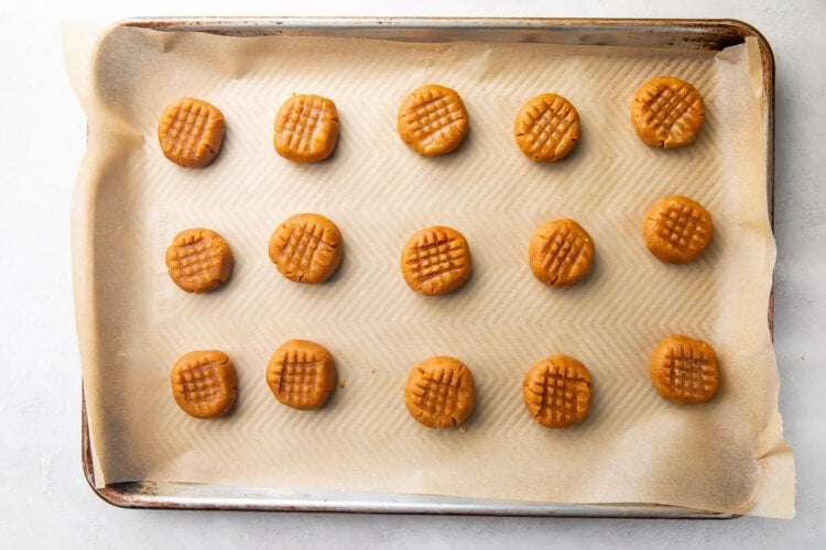 Unbaked peanut butter cookies on baking sheet