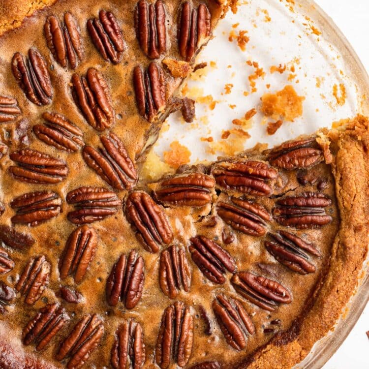 keto pecan pie in a pie dish with a slice removed