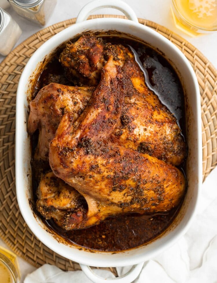 overhead image of baked turkey wings in a baking dish with beer on the side