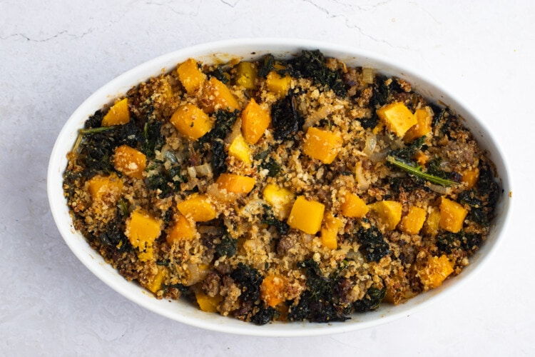 Baked butternut squash casserole in large white baking dish