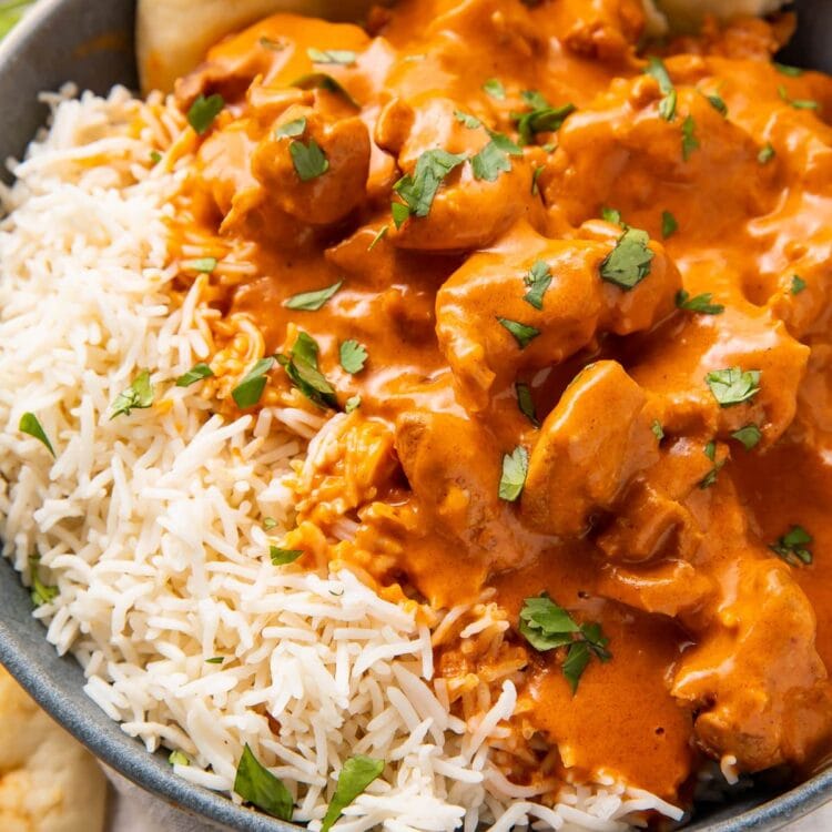 Instant Pot butter chicken, steamed basmati rice, and naan in a large grey bowl