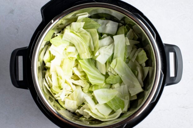 Roughly chopped cabbage and diced onion in Instant Pot