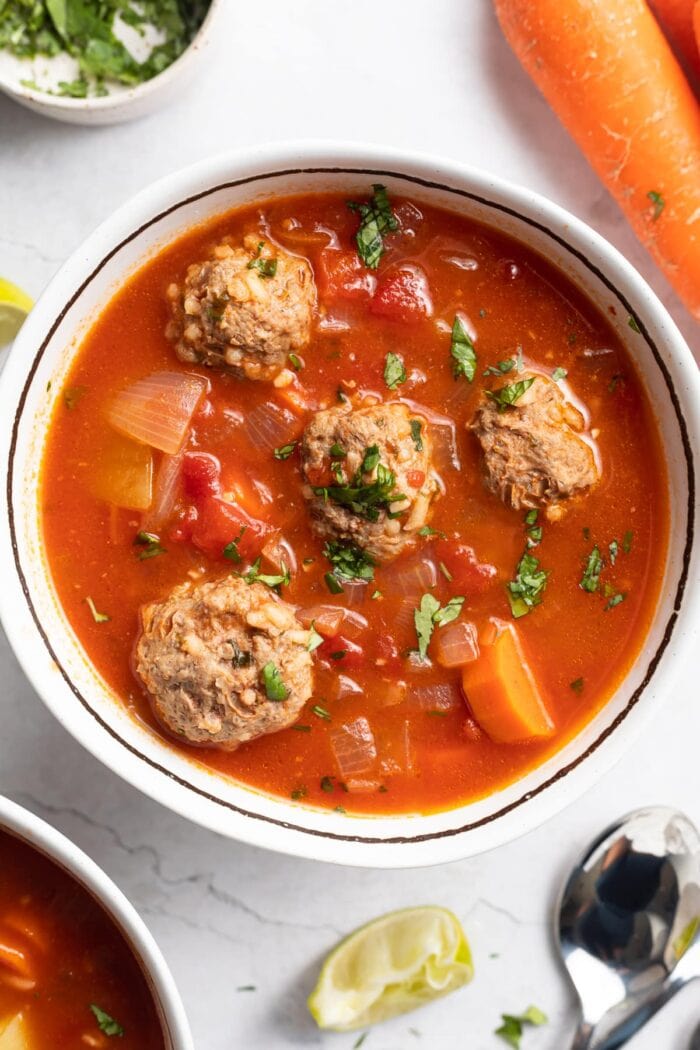 overhead image of albondigas soup in a bowl with fresh cilantro on top