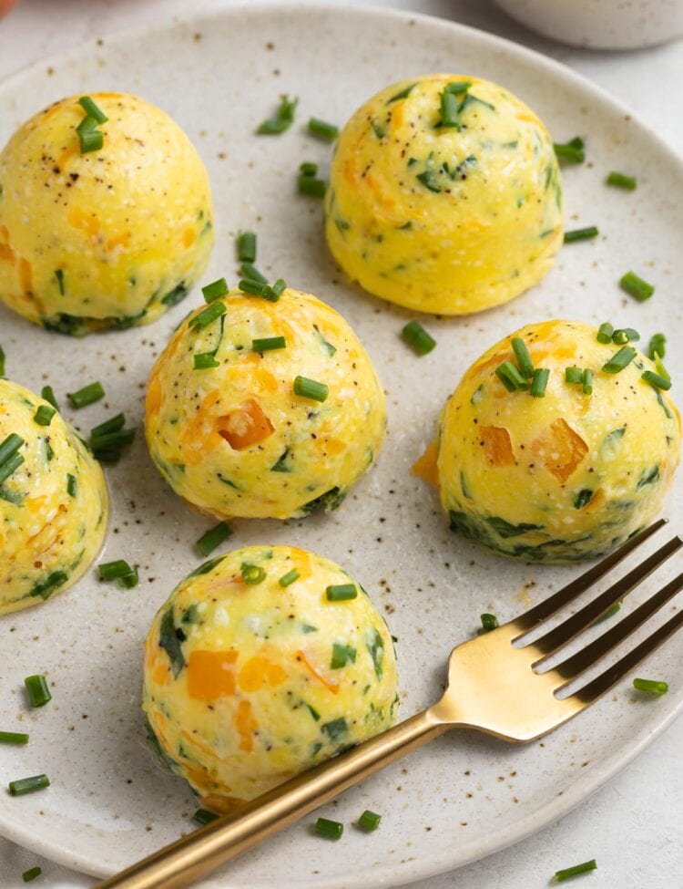 instant pot egg bites on a plate with fresh chopped chives on top