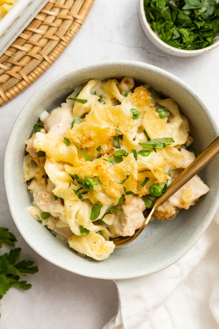 turkey casserole in a bowl with parsley on the side