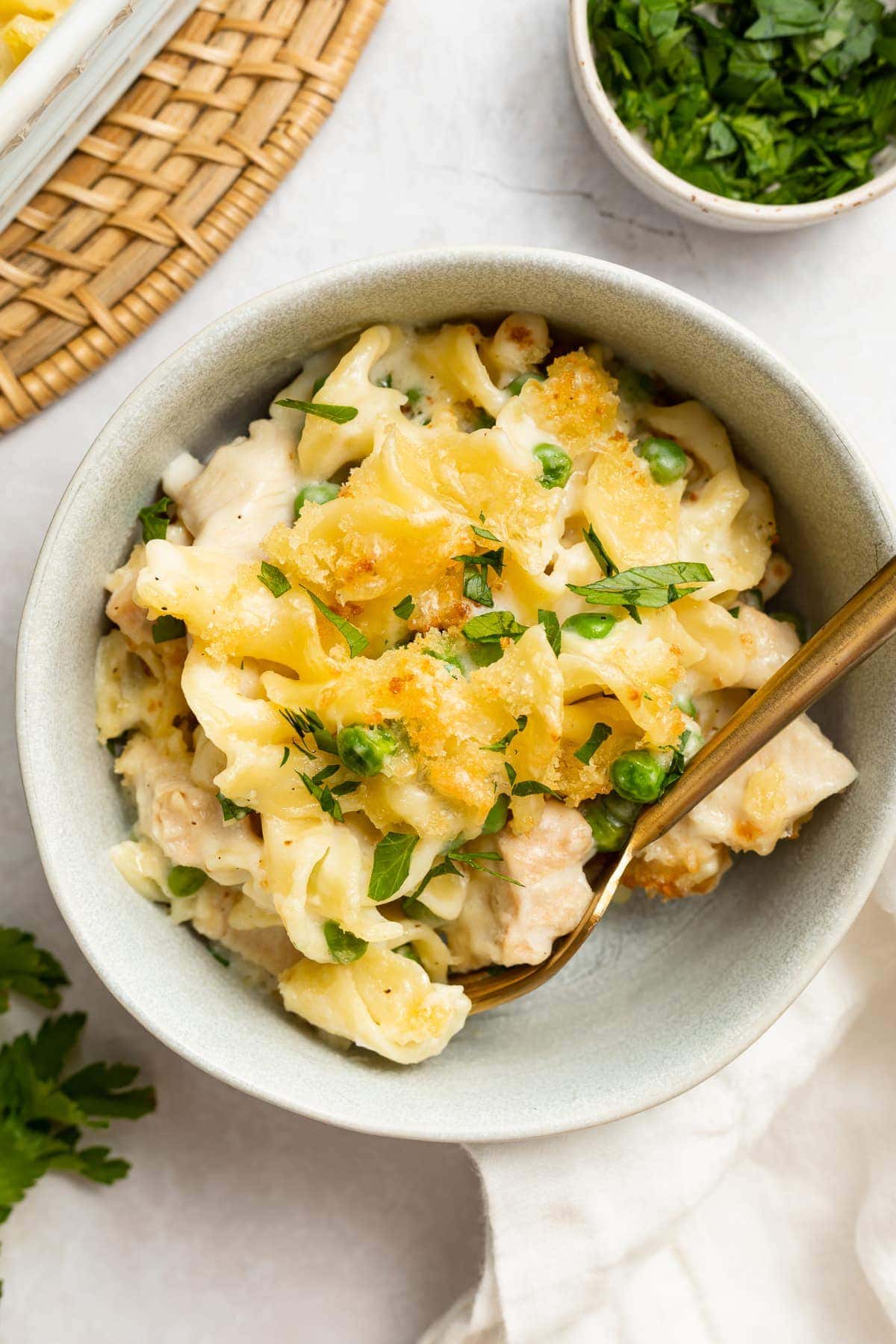 turkey casserole in a bowl with parsley on the side.