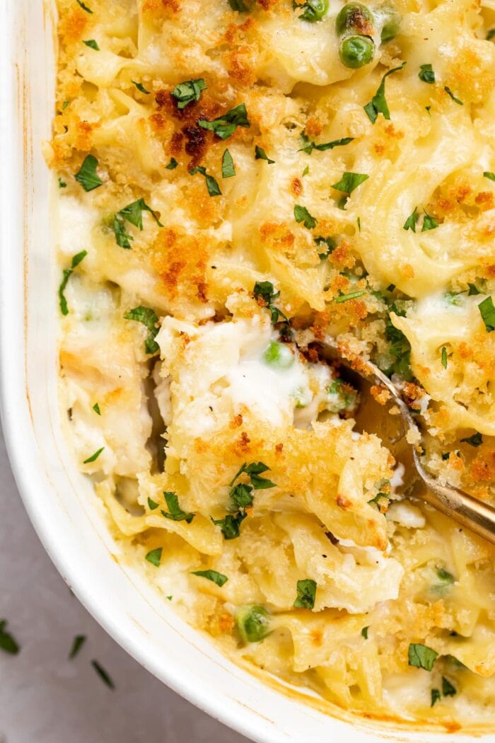 overhead image of turkey casserole being scooped out of a baking dish