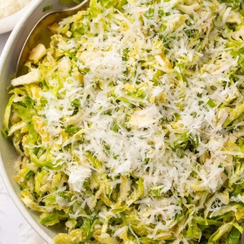 Overhead view of a bowl of shaved Brussels sprouts salad with lemon and parmesan
