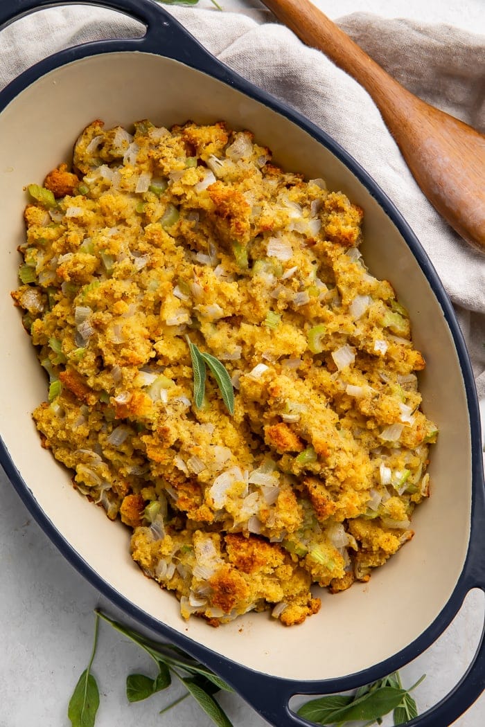 Overhead view of cornbread stuffing in a large blue casserole dish