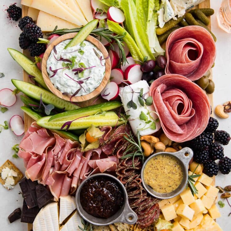 Overhead view of a keto charcuterie board with cheese, meat, nuts, veggies, and dips