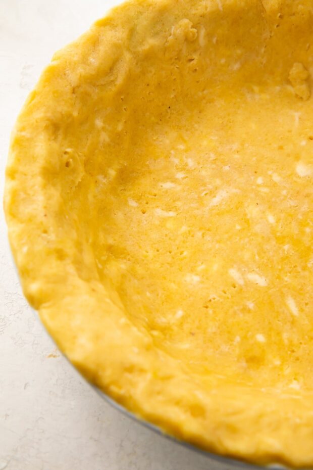 Overhead view of a keto pie crust in a pie dish