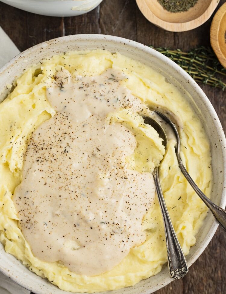 White gravy atop a large bowl of mashed potatoes