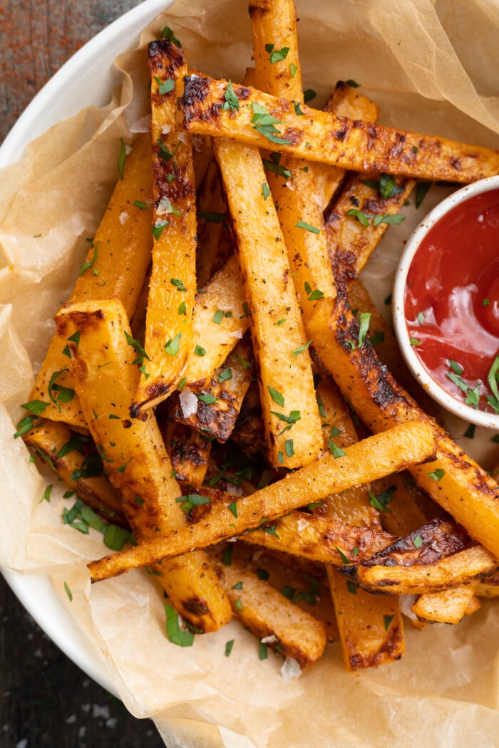 overhead image of rutabaga fries in a bowl with a side of ketchup