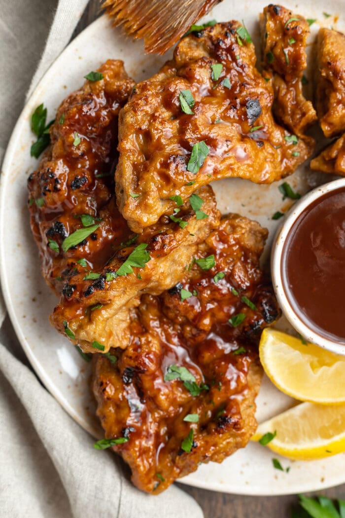 close-up overhead image of seitan grilled chicken with vegan bbq sauce on a plate