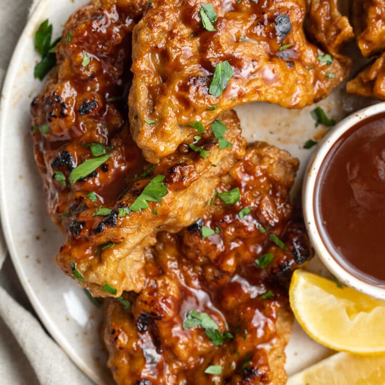 close-up overhead image of seitan grilled chicken with vegan bbq sauce on a plate