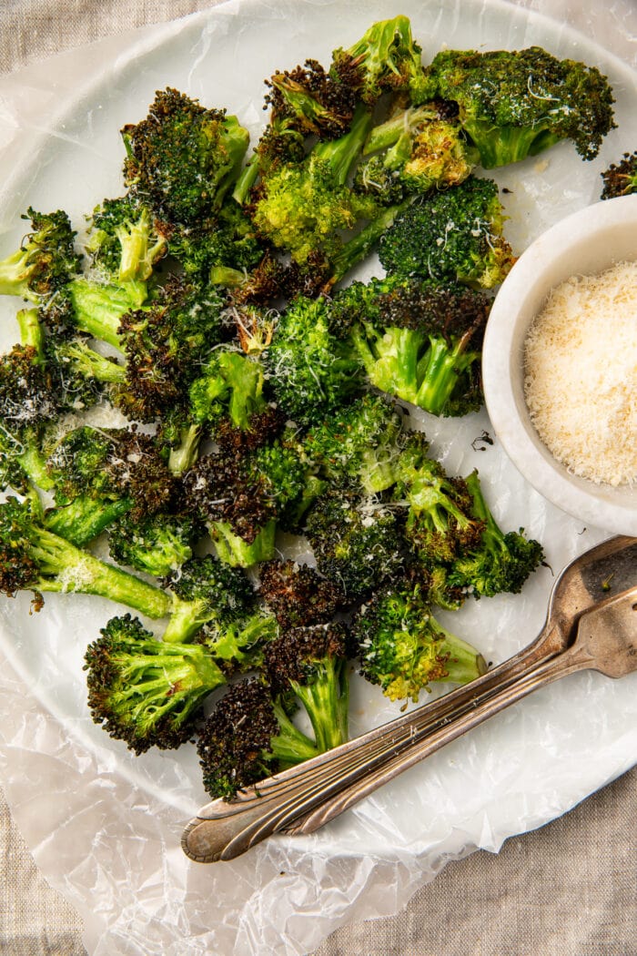 Overhead view of air fryer broccoli on a plate with dipping sauce